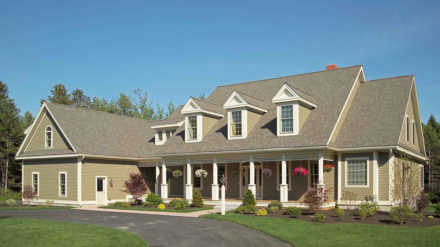 Large country house with gable roof and a curving driveway