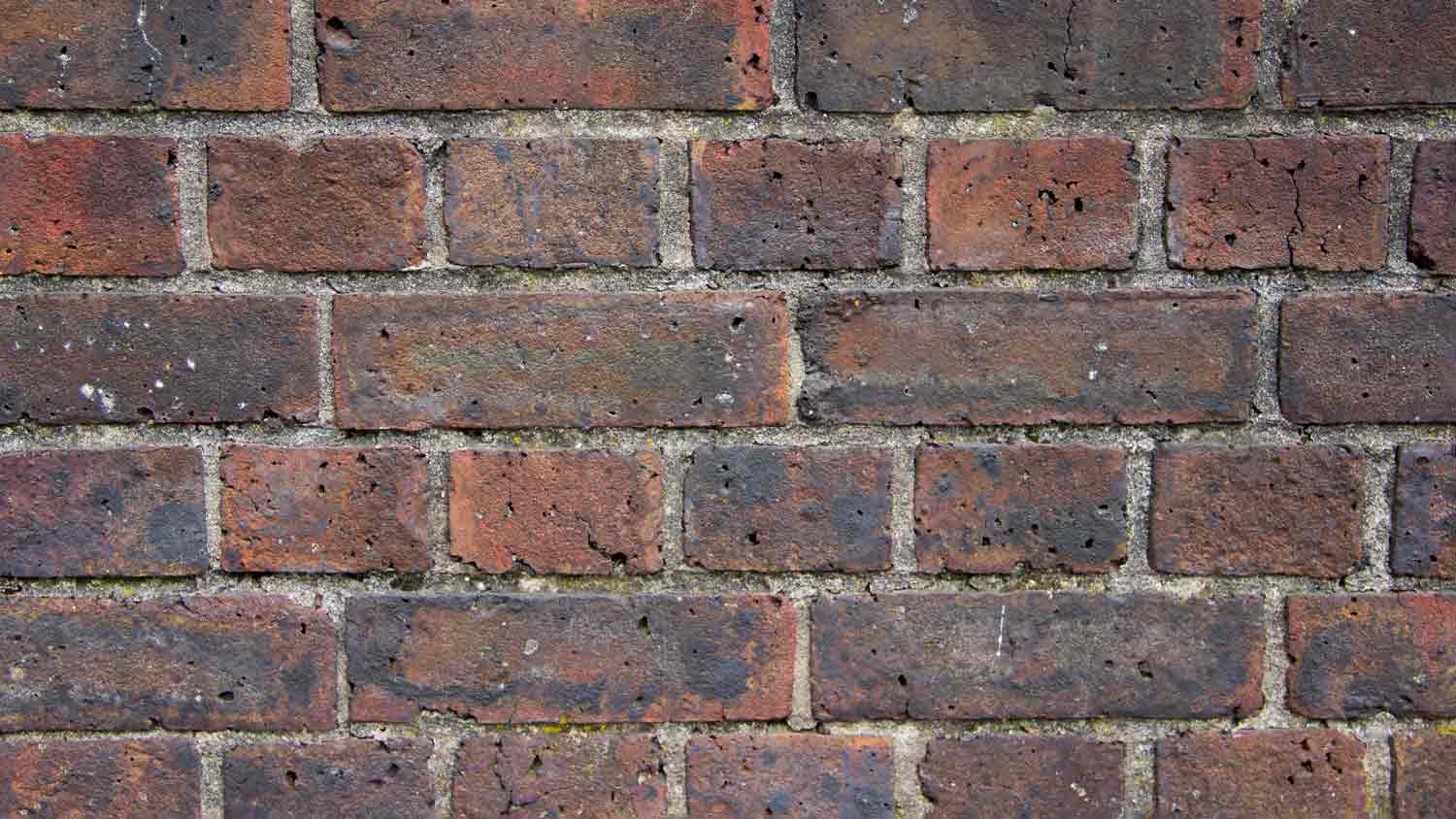 Brick wall with black stains