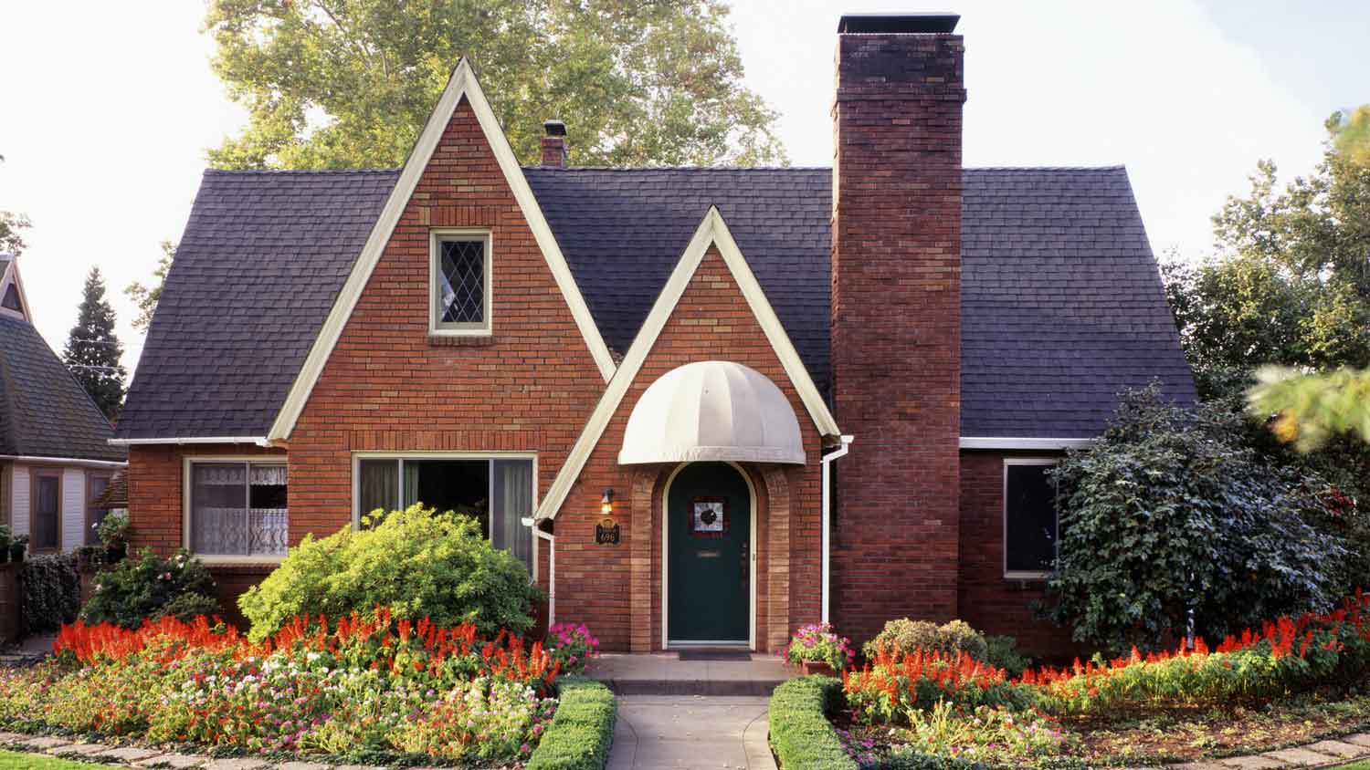 A brick house with a lovely front yard