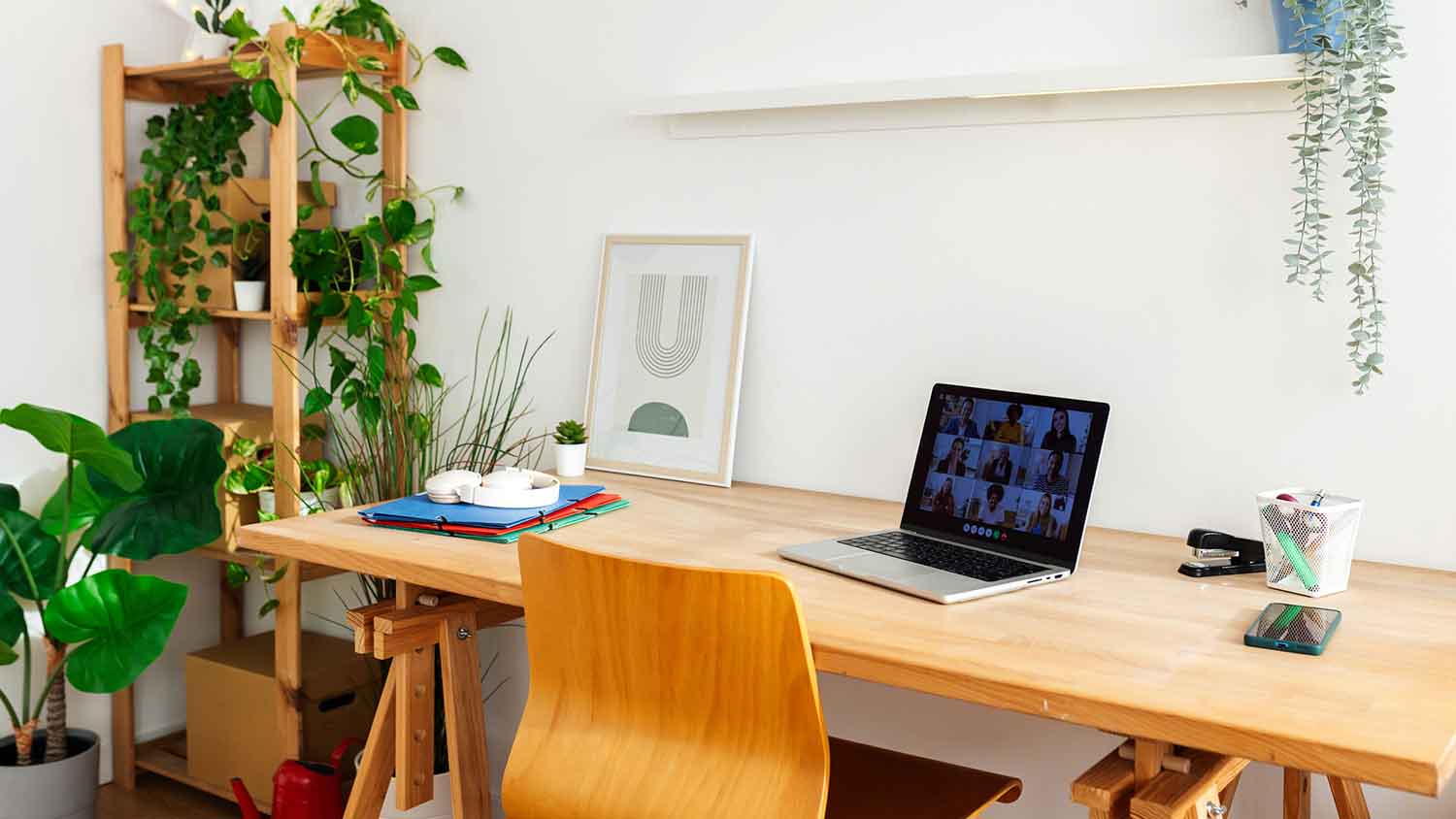 Home office space with white walls and a wooden desk 