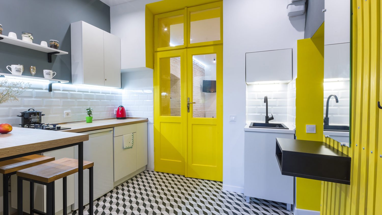 A bright yellow door leading to a kitchen 