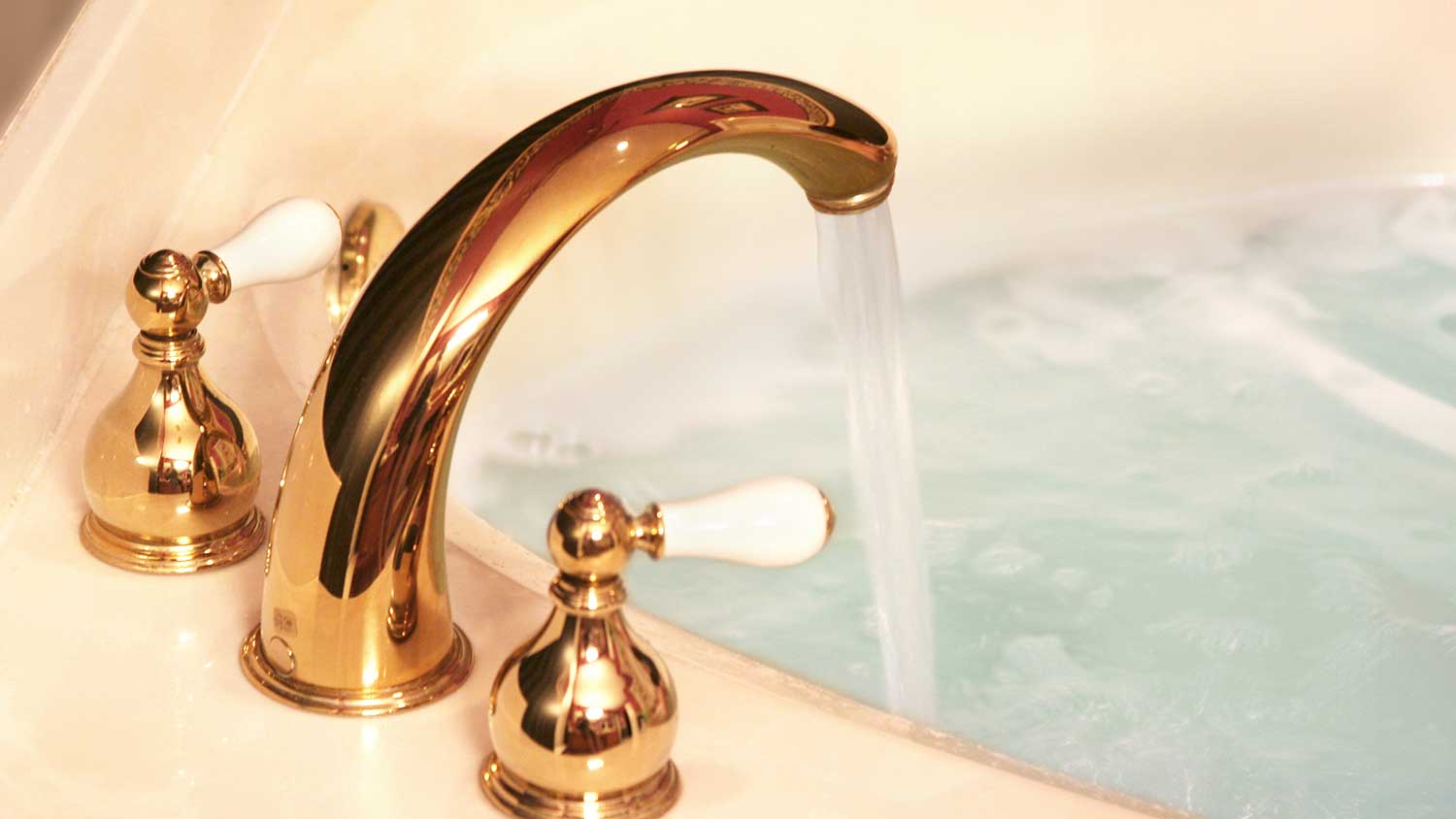 Open faucet filling a bathtub