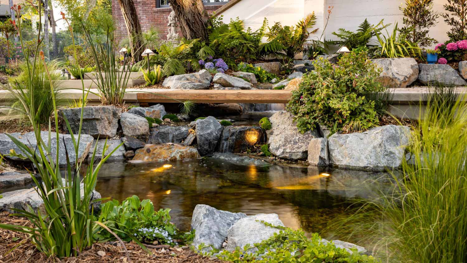 A view of a backyard brook with built-in bench