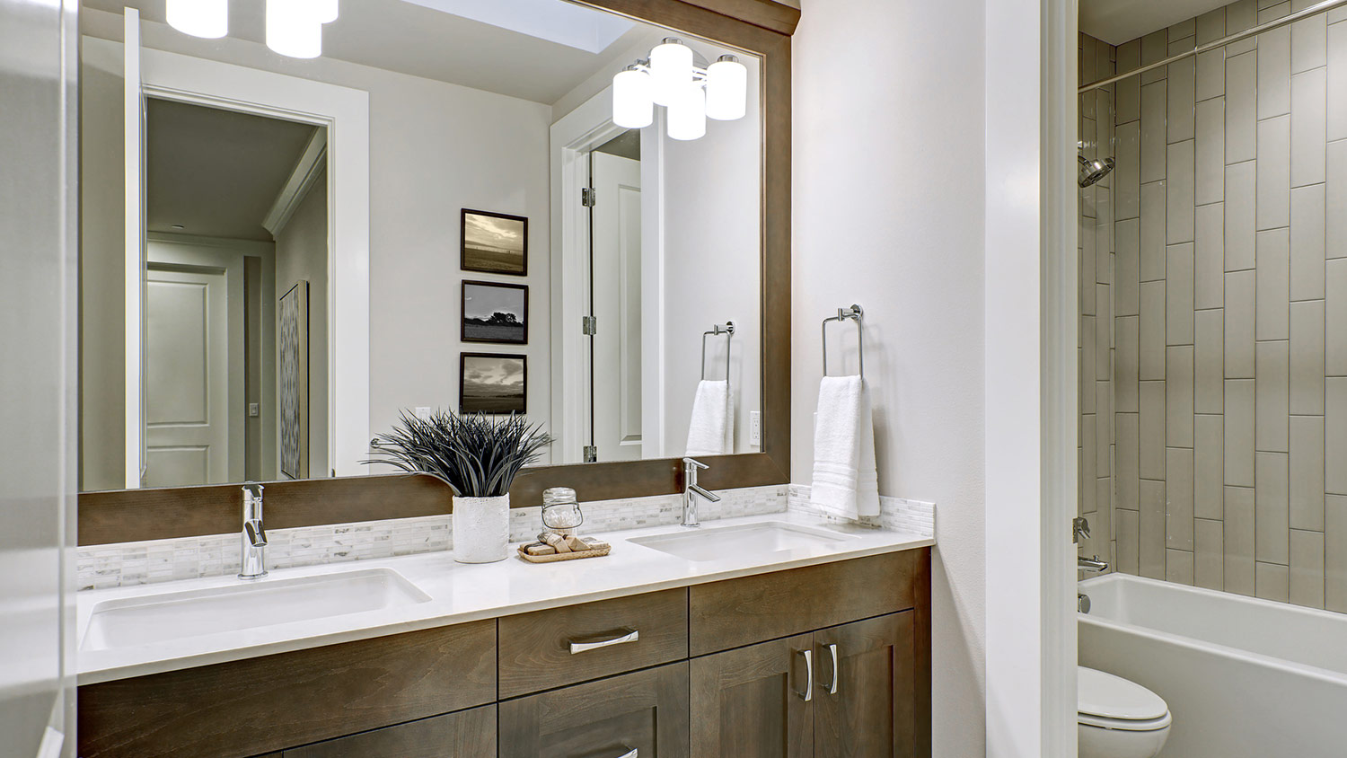 White and brown bathroom with double vanity