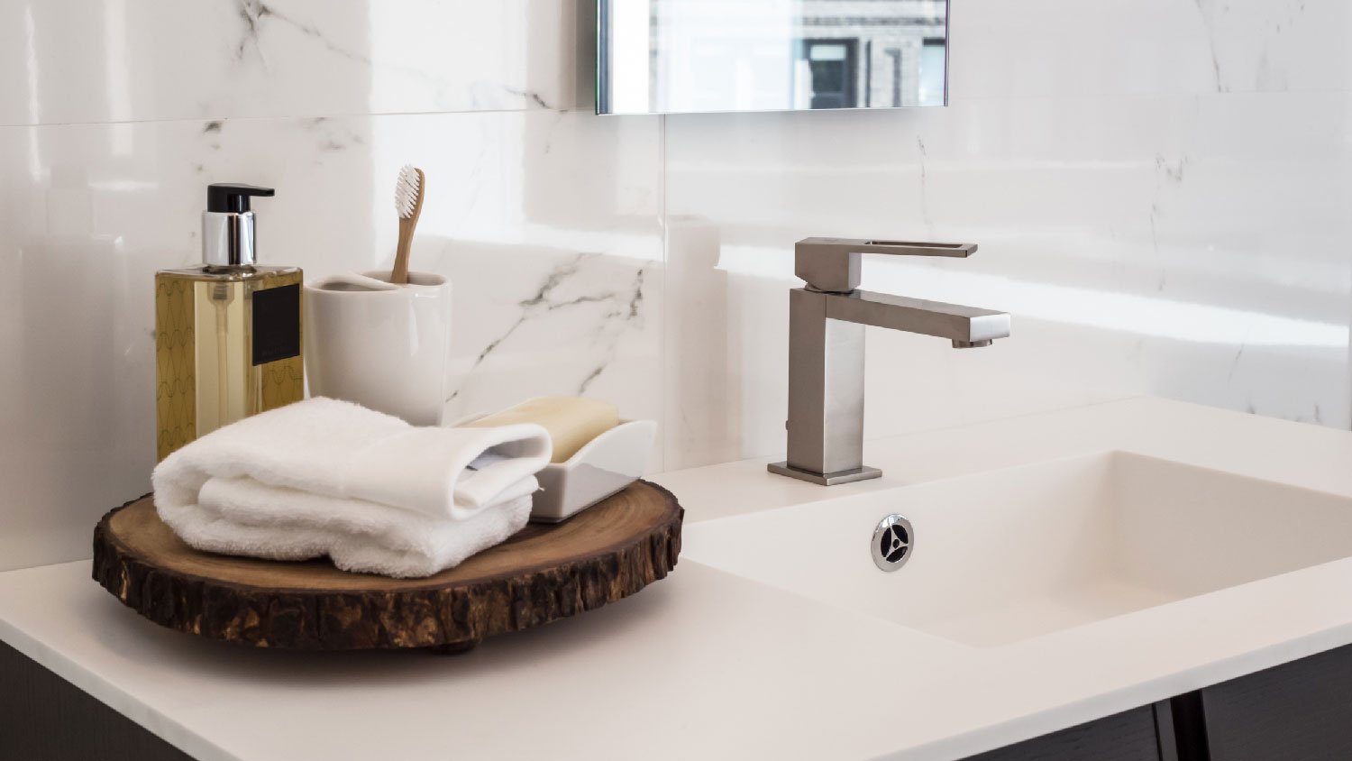 A brushed nickel faucet on a contemporary sink