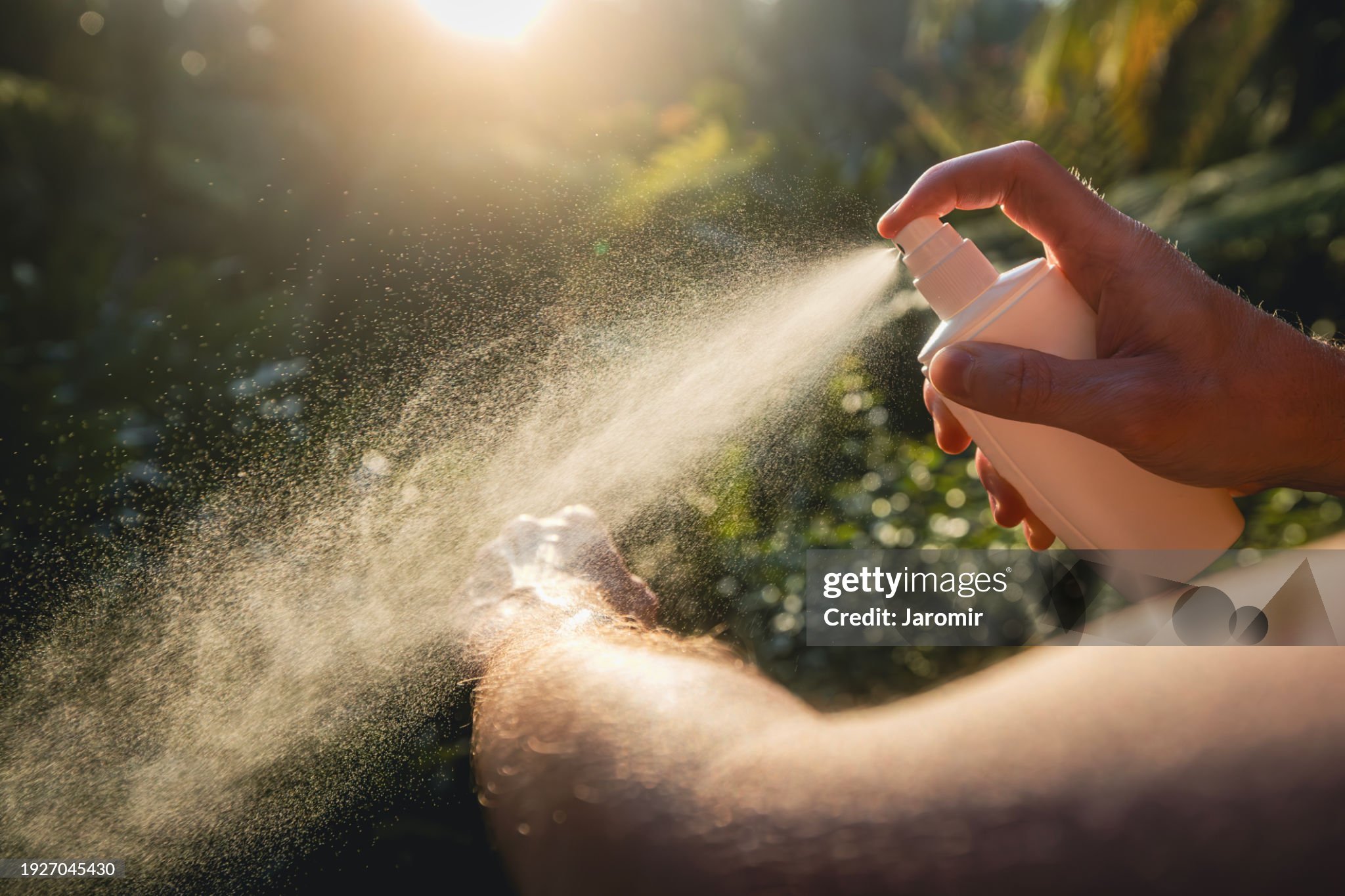 Man while applying insect repellent