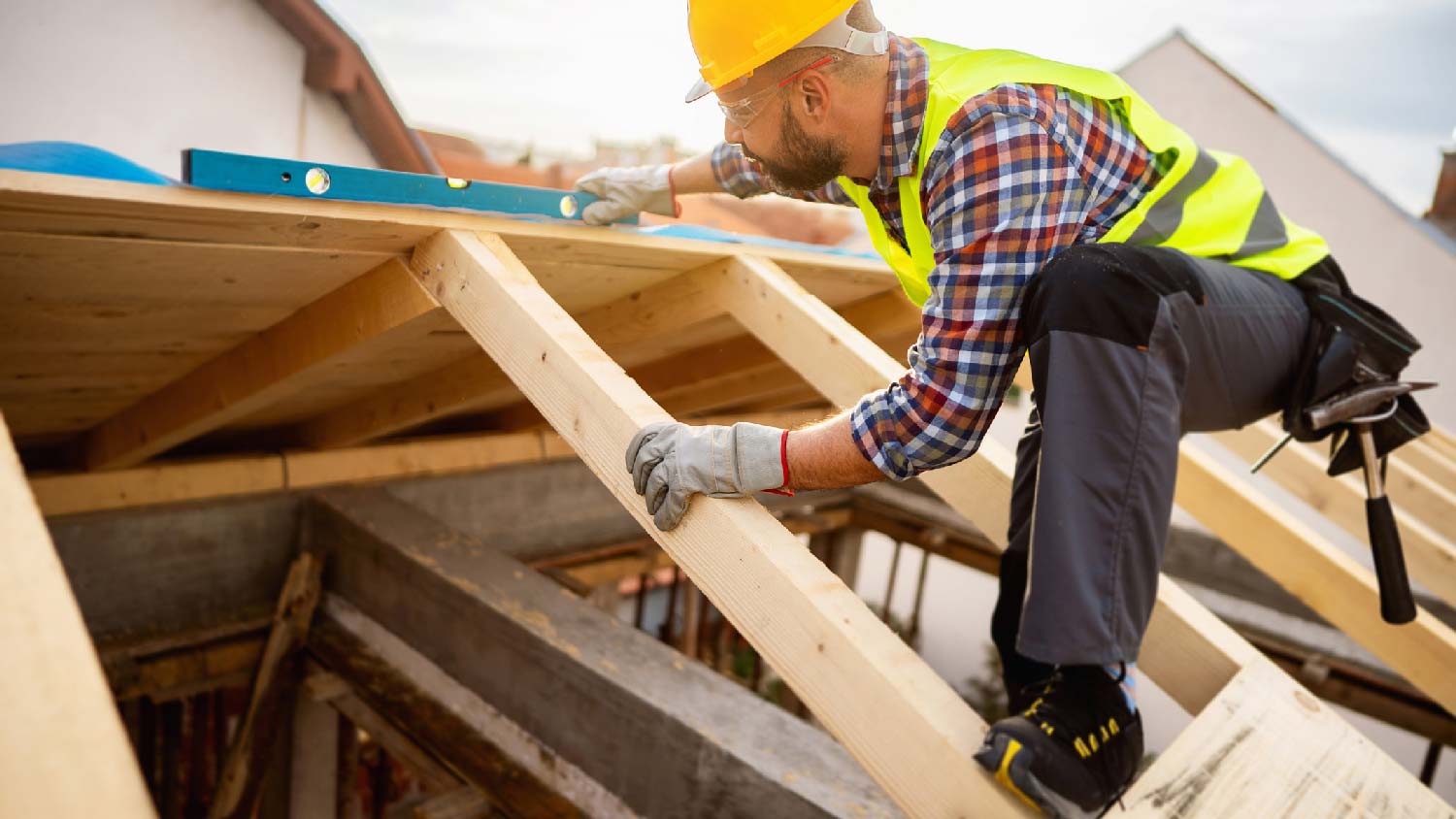 A builder installing roof rafters