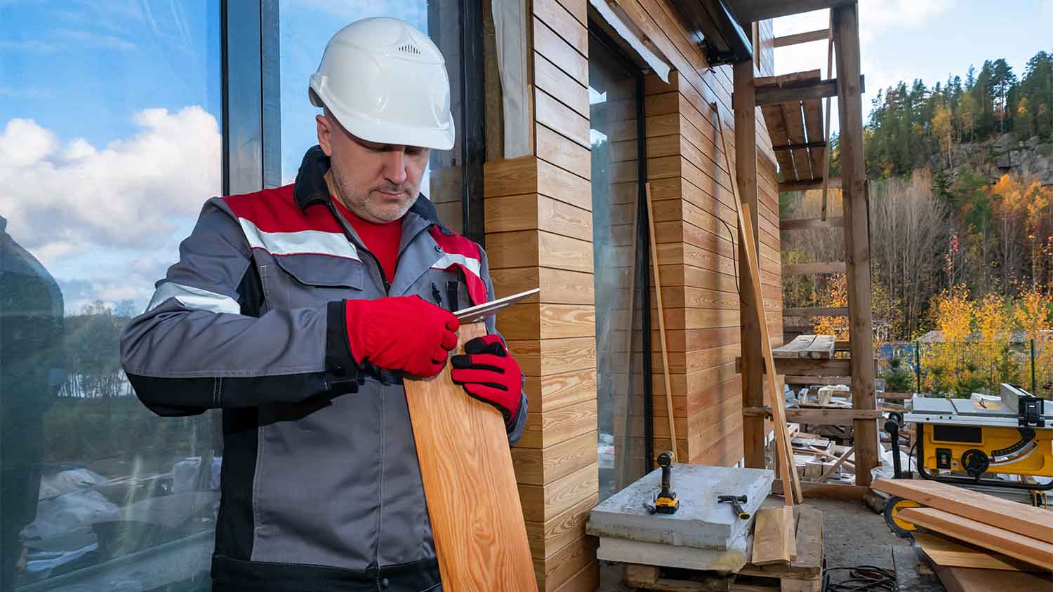  builder preparing wood siding for home