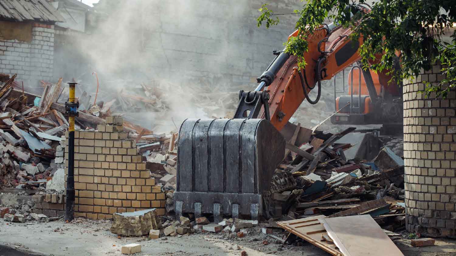 A bulldozer demolishing a house