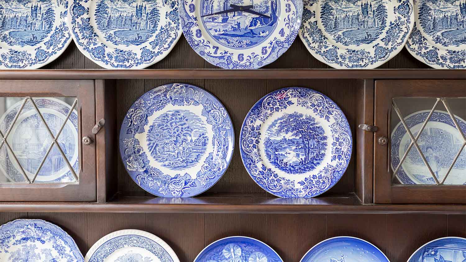 A cabinet with plates on display