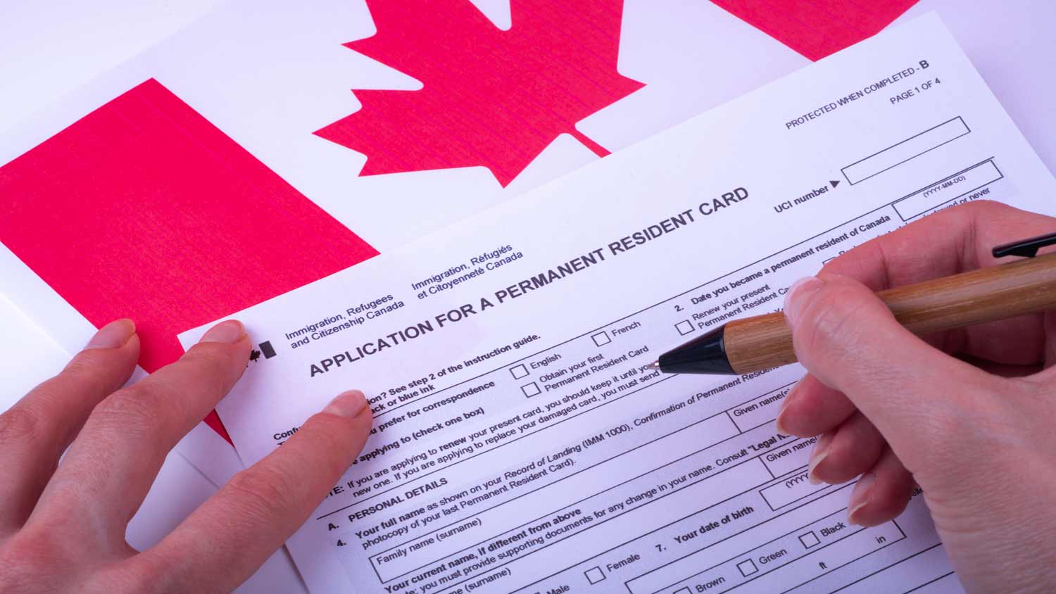 person filling out application for canadian residence