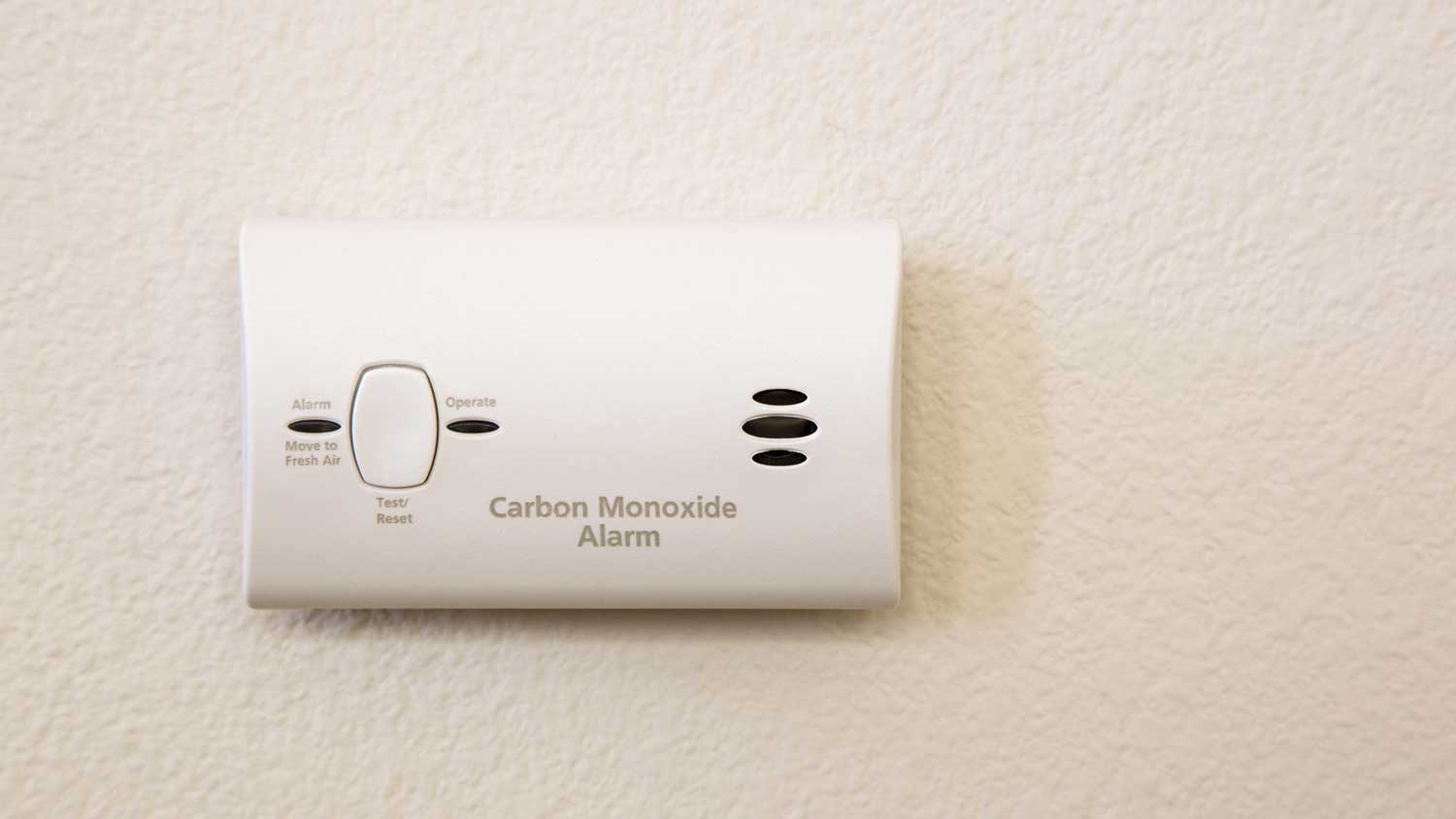 Closeup of a carbon monoxide detector mounted on a wall