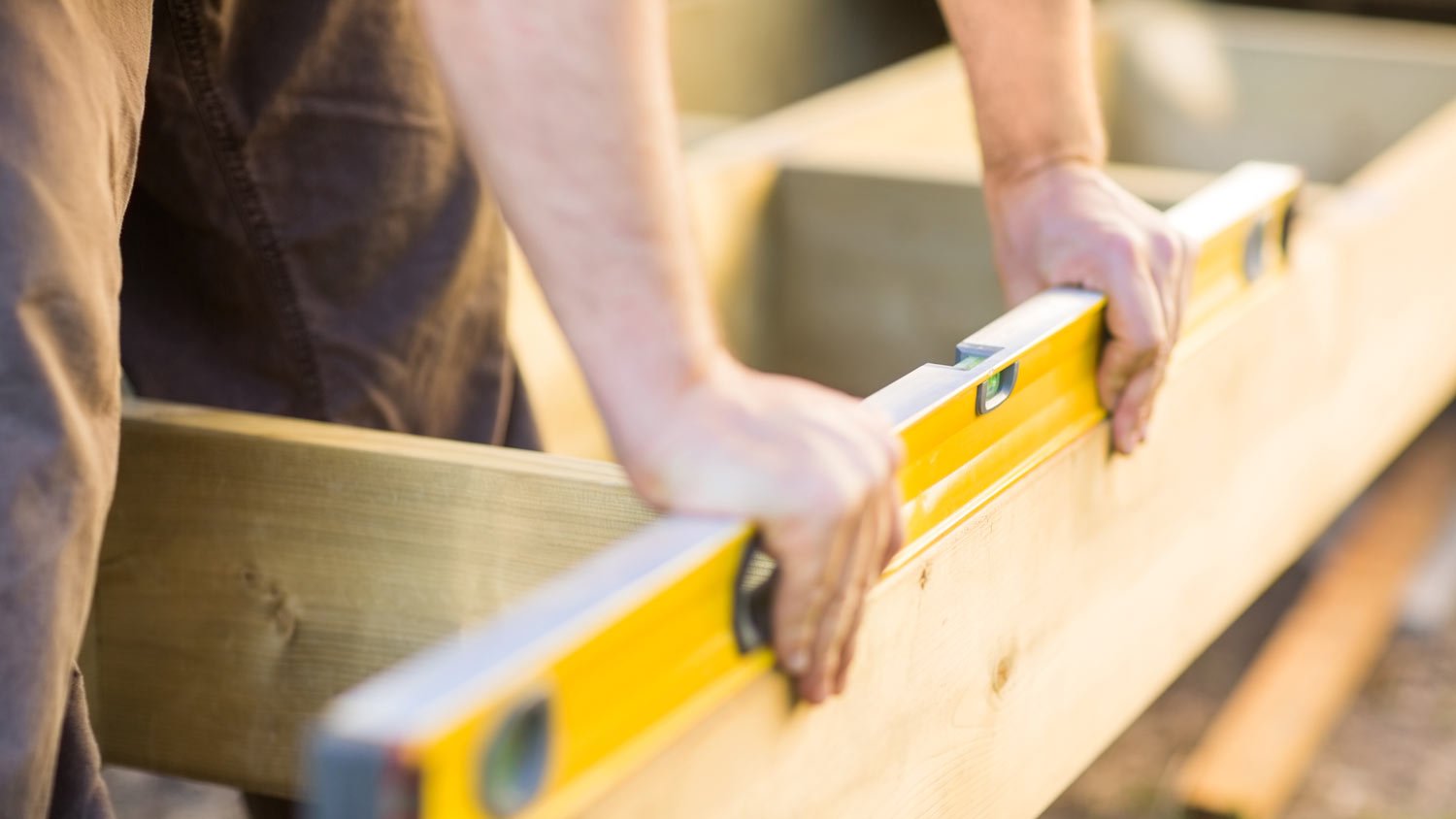 Close-up of a carpenter building a wooden deck