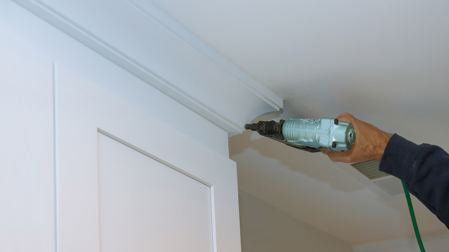 carpenter drilling crown molding  