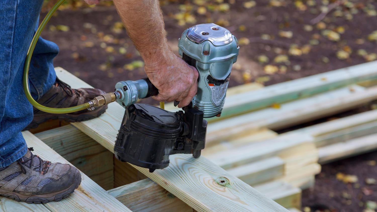 A carpenter laying the ground to install porch columns