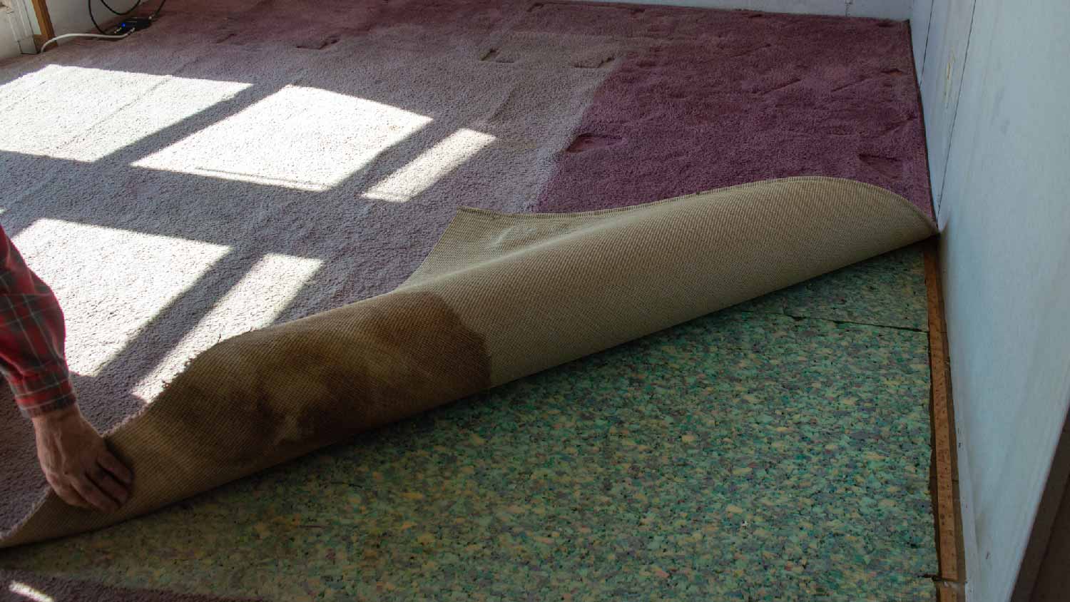 Replacing a carpet with padding underneath it
