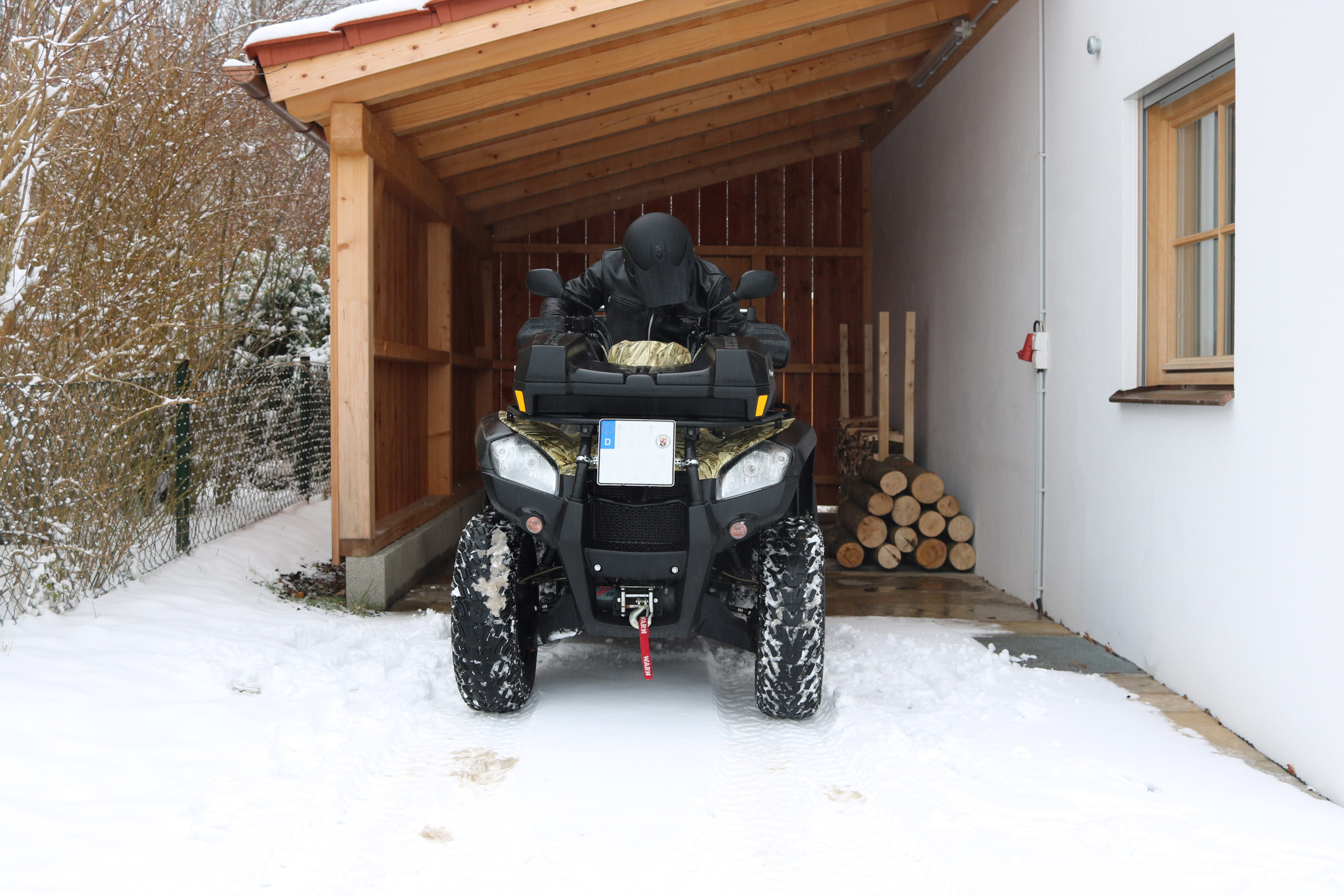 Attached carport with ATV parked in front