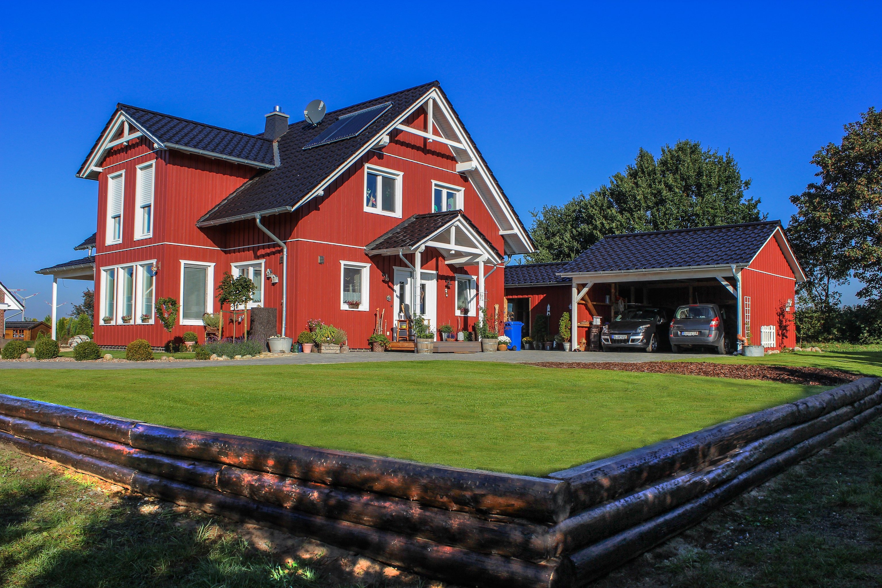 Large double carport attached to farm-style home