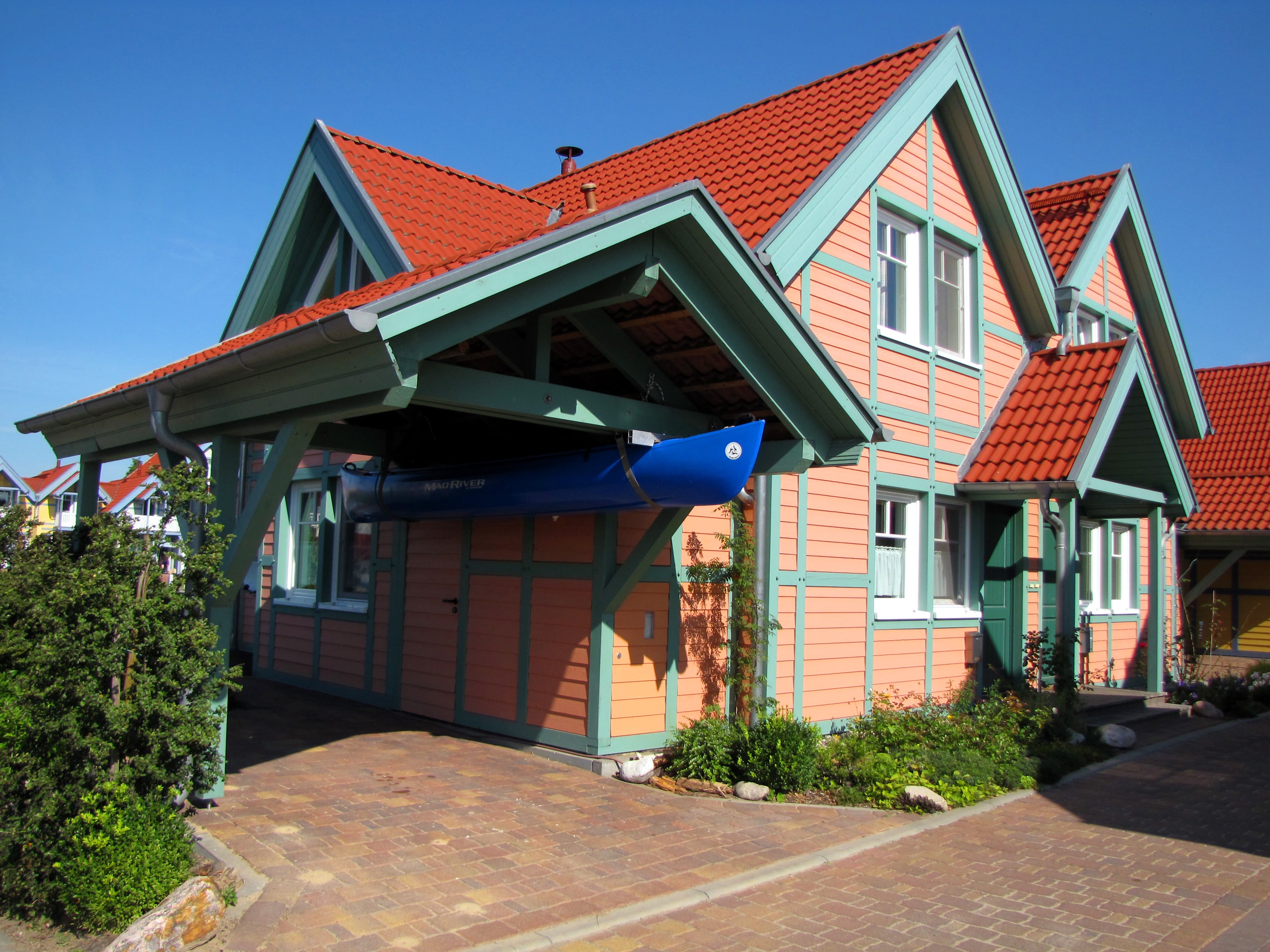 Wooden house with attached carport and boat storage