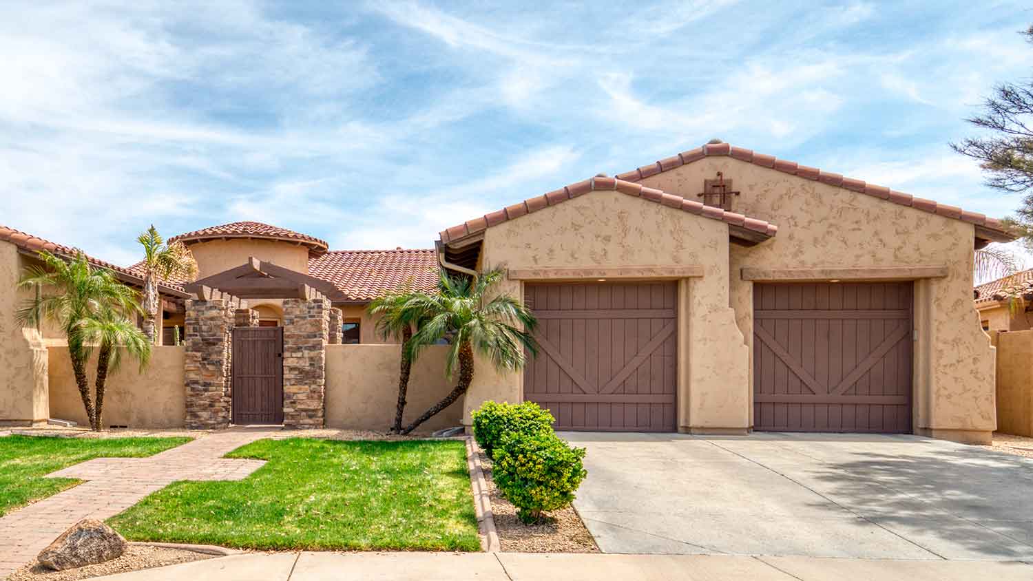 Large south-western style house with cat face stucco finish