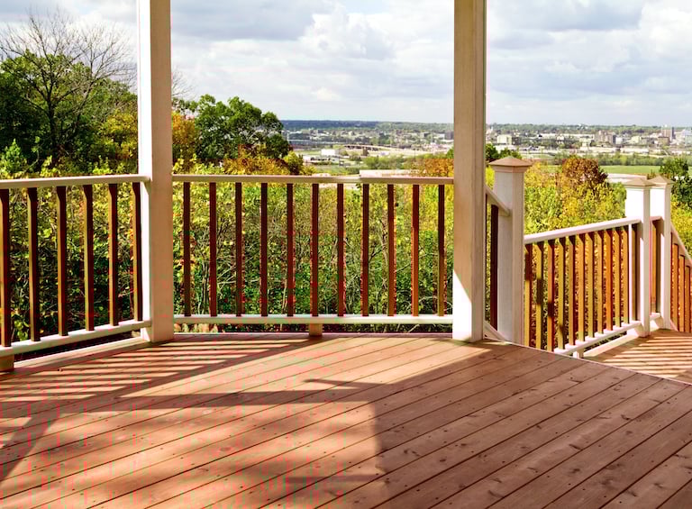 a cedar deck overlooking the city in the distance