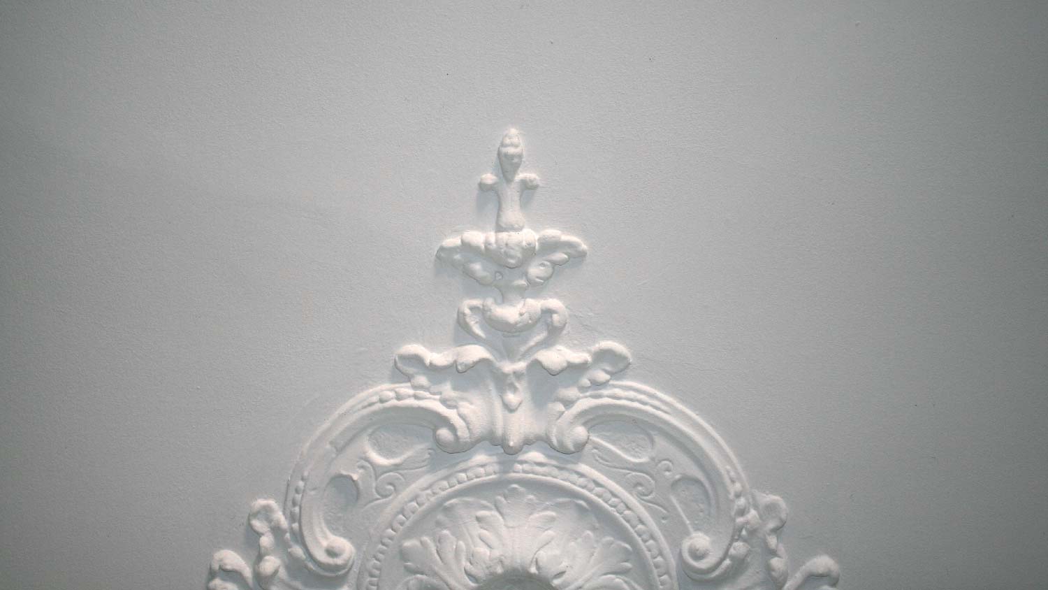 A detail of an ornament on a ceiling