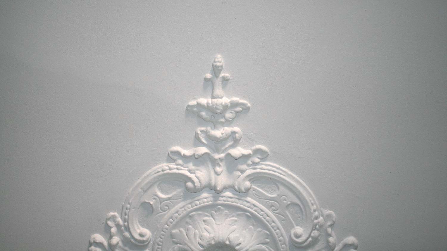 A detail of an ornament on a ceiling