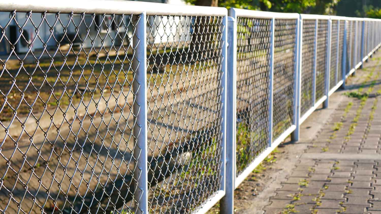 Chain link fence along the sidewalk