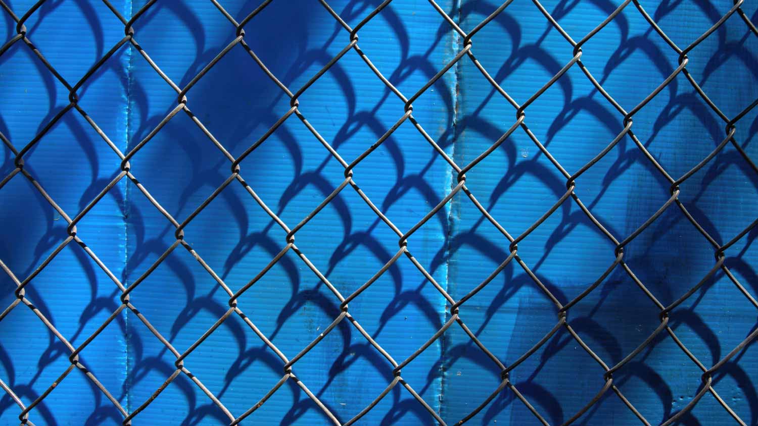 Chain Link fence against Blue background