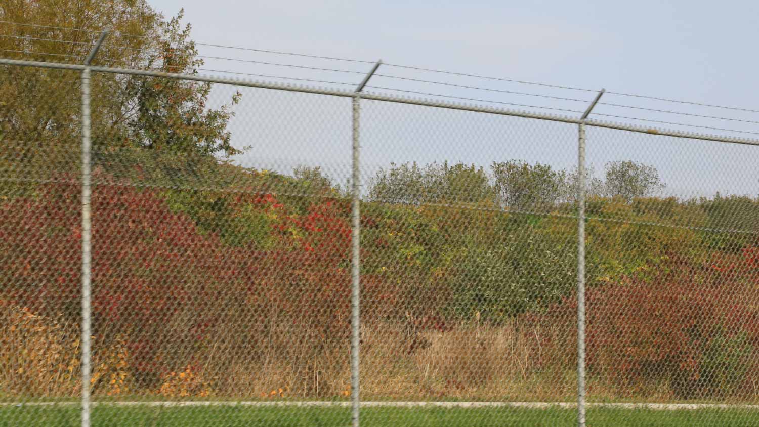 Chain link fence with barbed wire