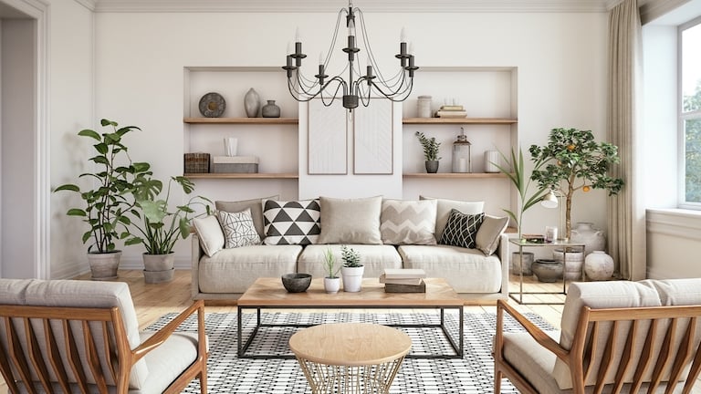 home living room with black chandelier hanging from ceiling and modern couch and armchairs underneath