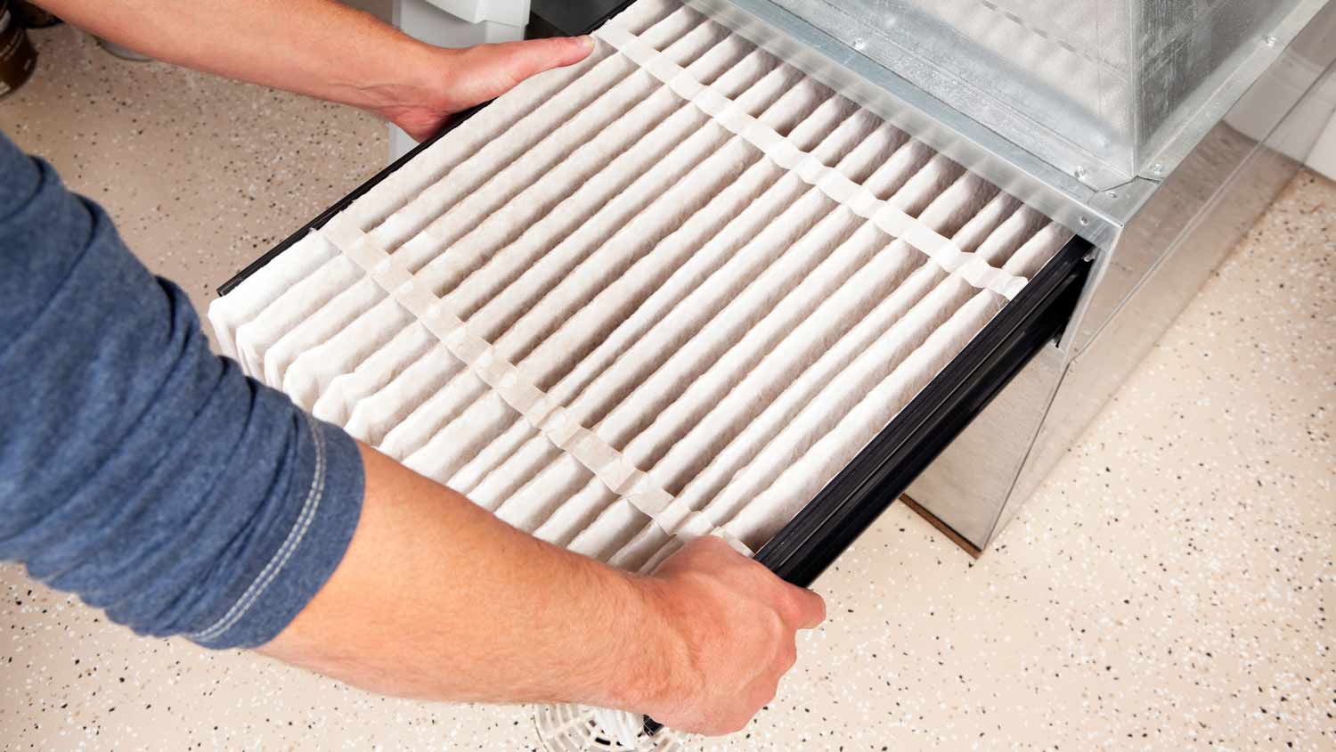 man changing furnace filter