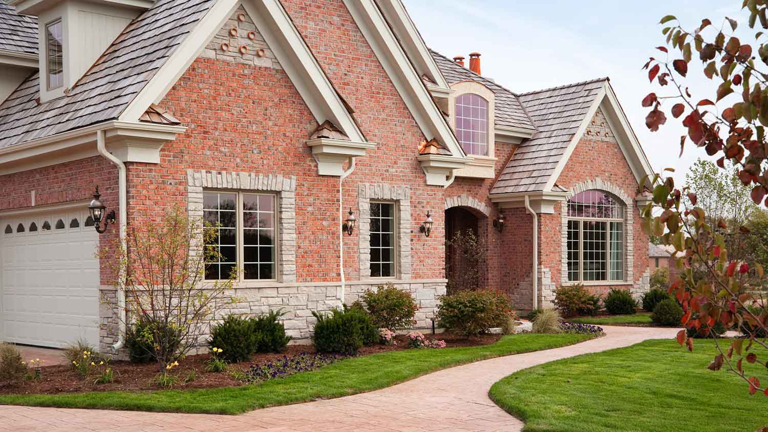Red brick house with a brick pathway