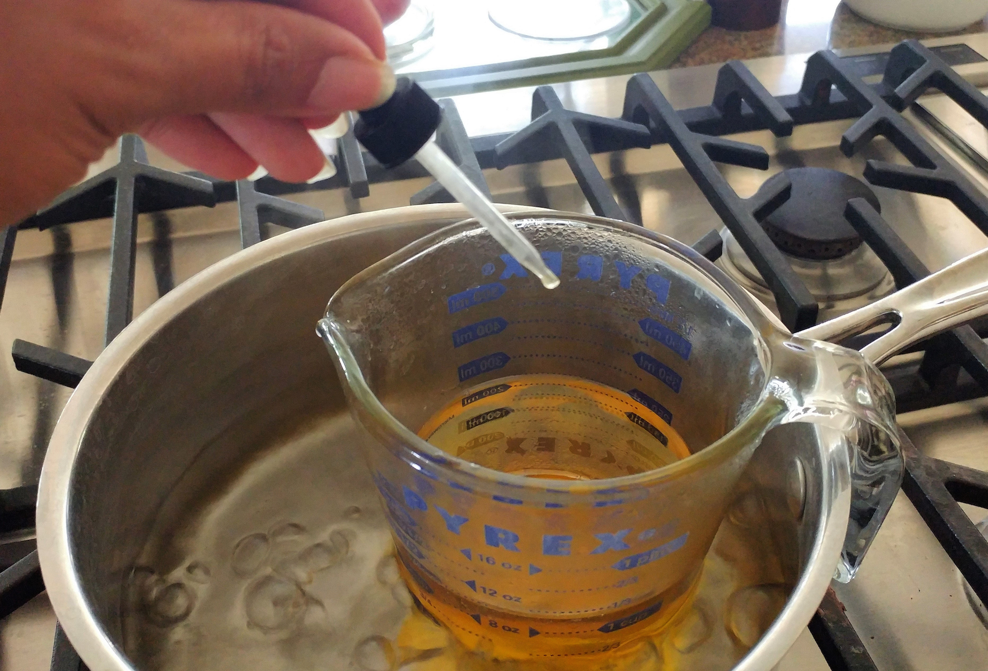 adding essential oils to beeswax