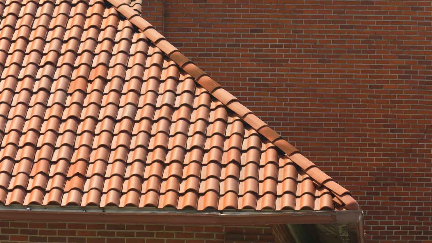 A clay tiled roof of a red brick house