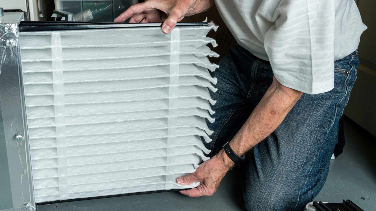 man checking clean air filter