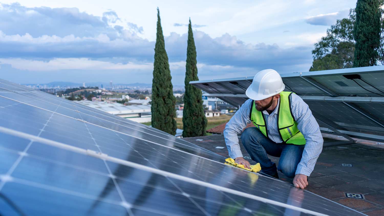 man cleaning solar panels with cloth