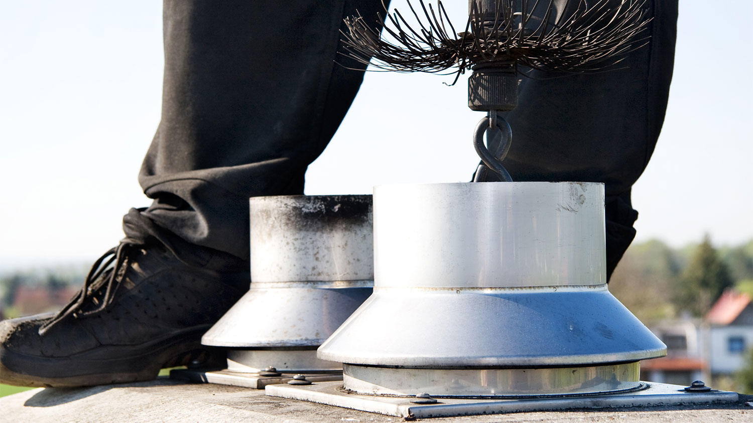 A view of someone cleaning a chimney