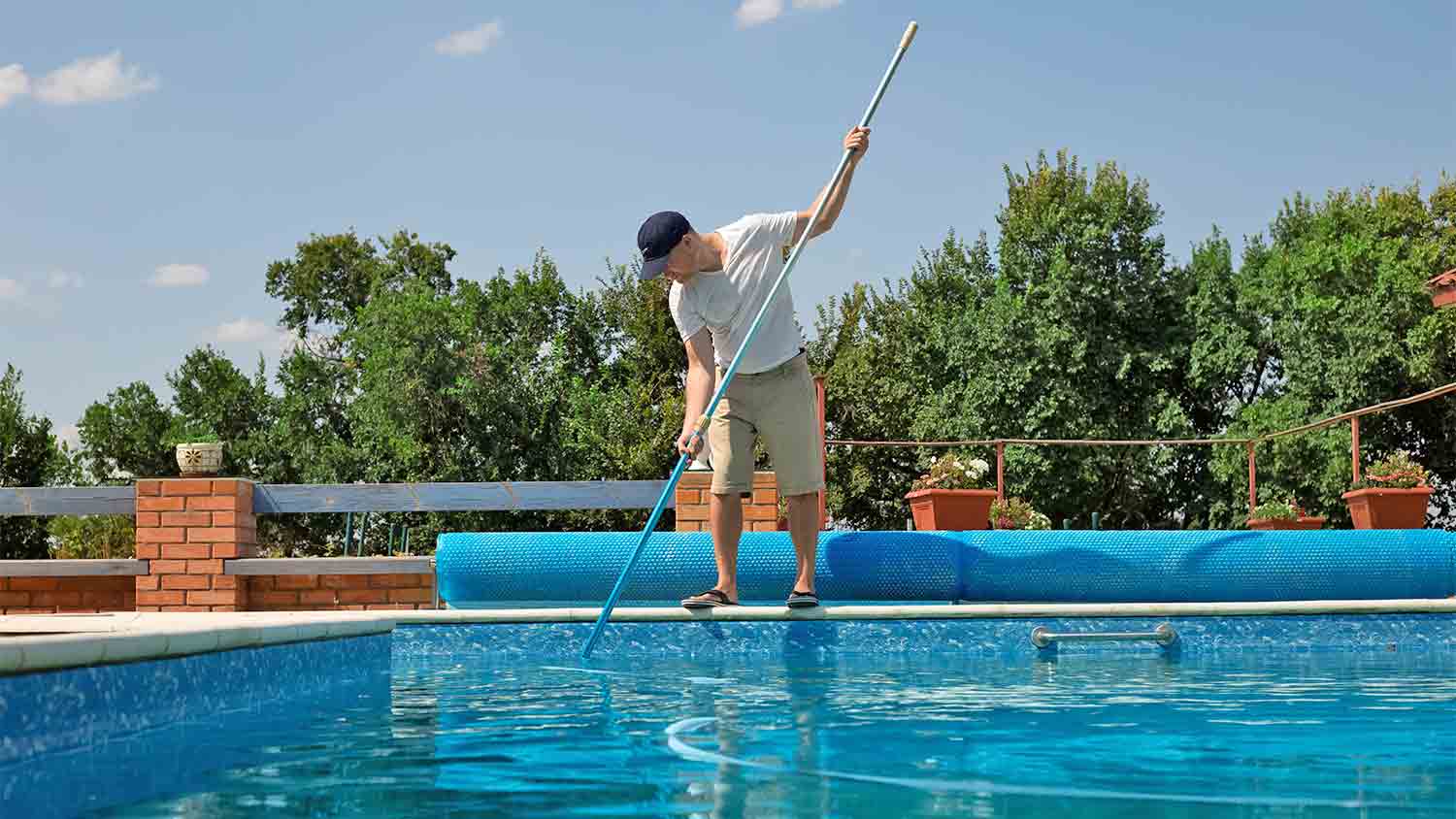 professional man cleaning swimming pool