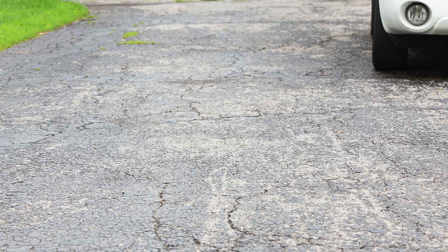 Close-up of asphalt cracks on a driveway