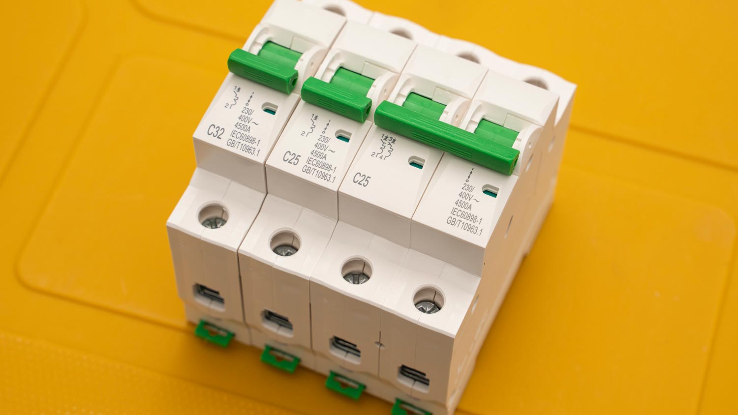 Close-up of a circuit breaker against a yellow background