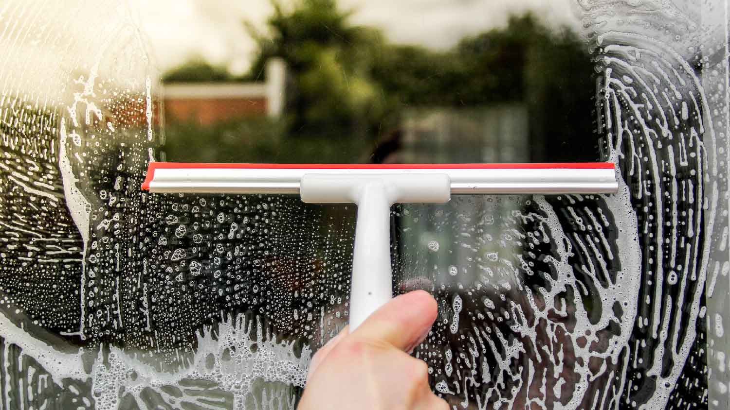 Close-up of cleaning an exterior window