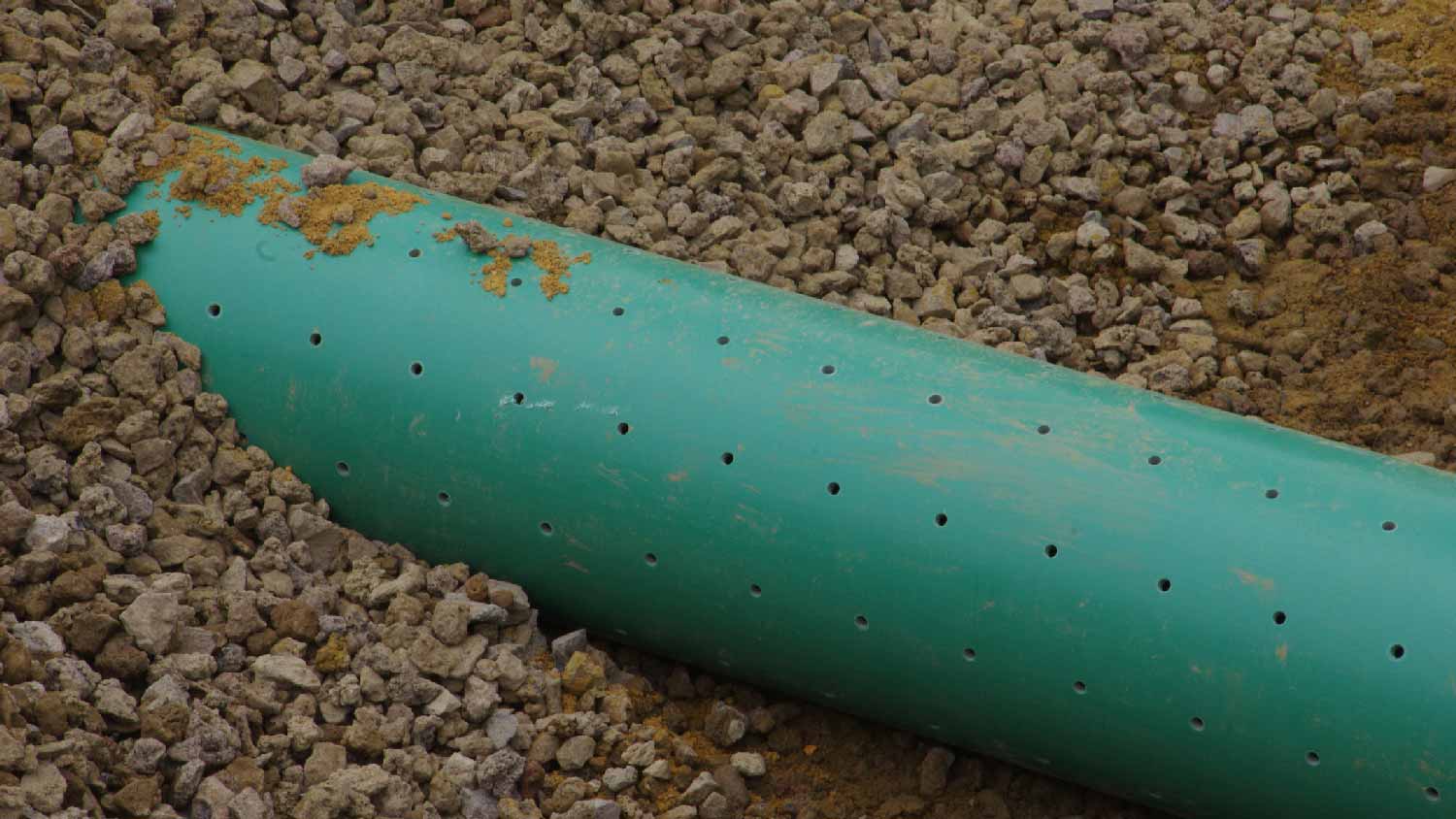 Close-up of a perforated drain pipe