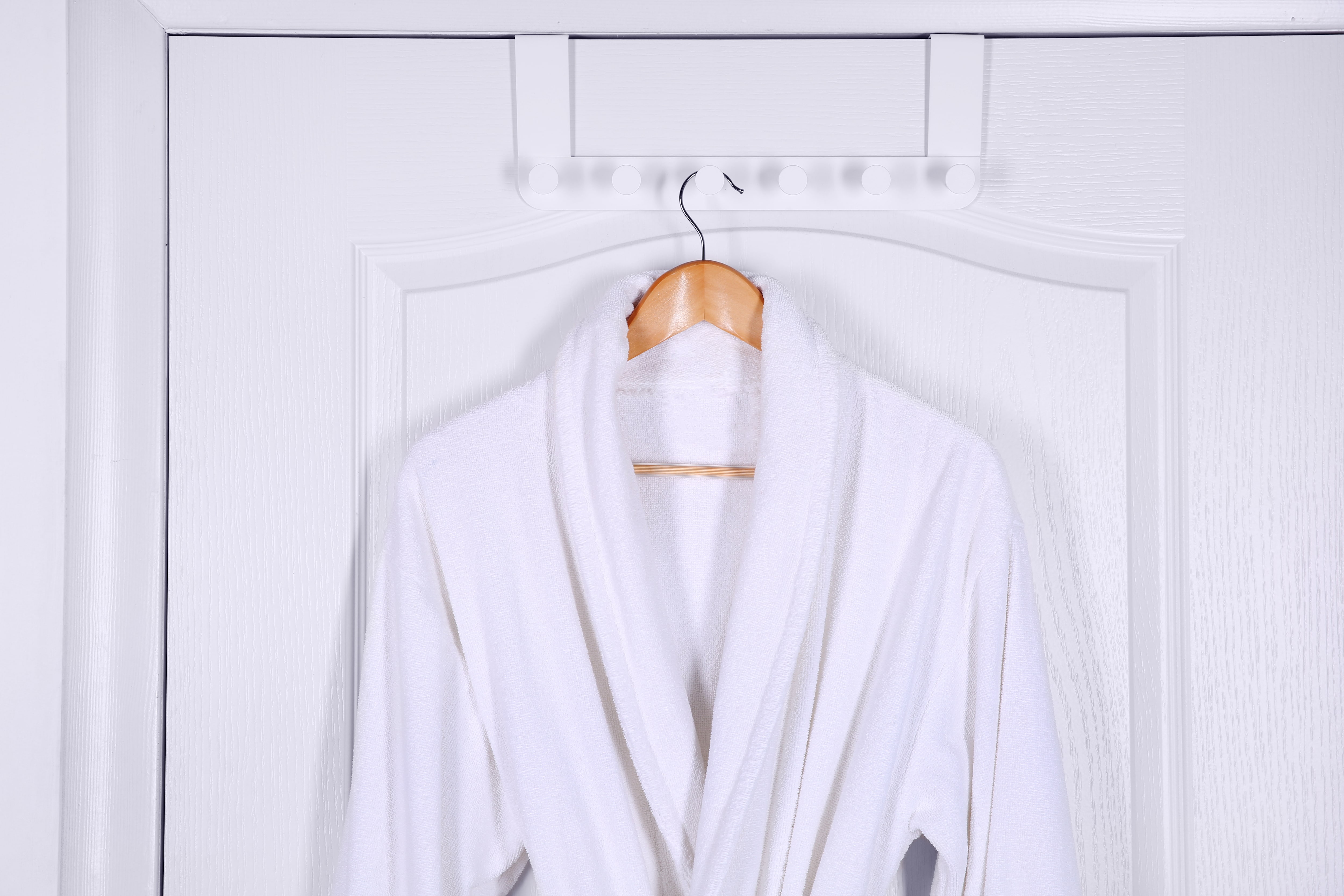 A robe hanging on an over-the-door hook