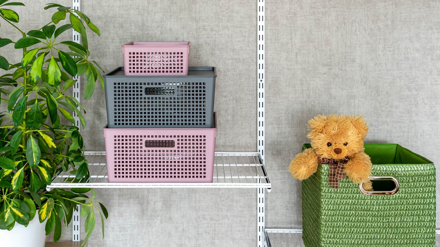 Closet with pink and gray plastic boxes or containers with lids 