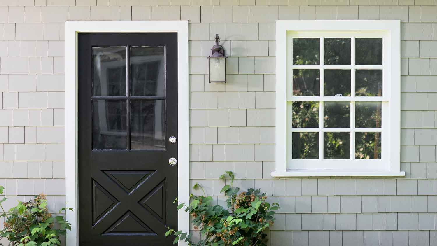 White window and black door with colonial grid style