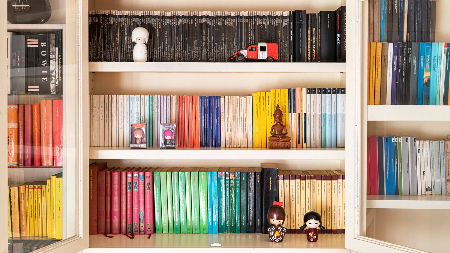 Books color-coordinated on a shelf