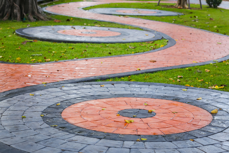 red and gray printed concrete designed in swirl patterns
