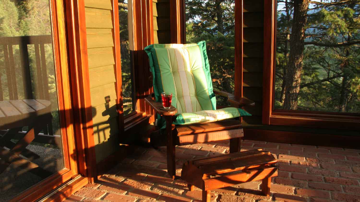 A comfy armchair in a screened-in porch