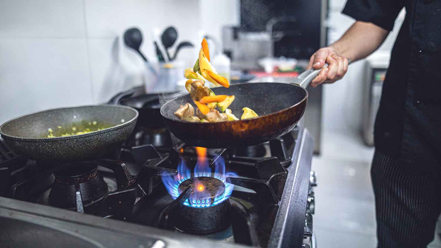 Chef using commercial-style cooktop